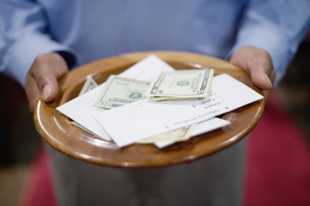 Man holding offering plate, close-up