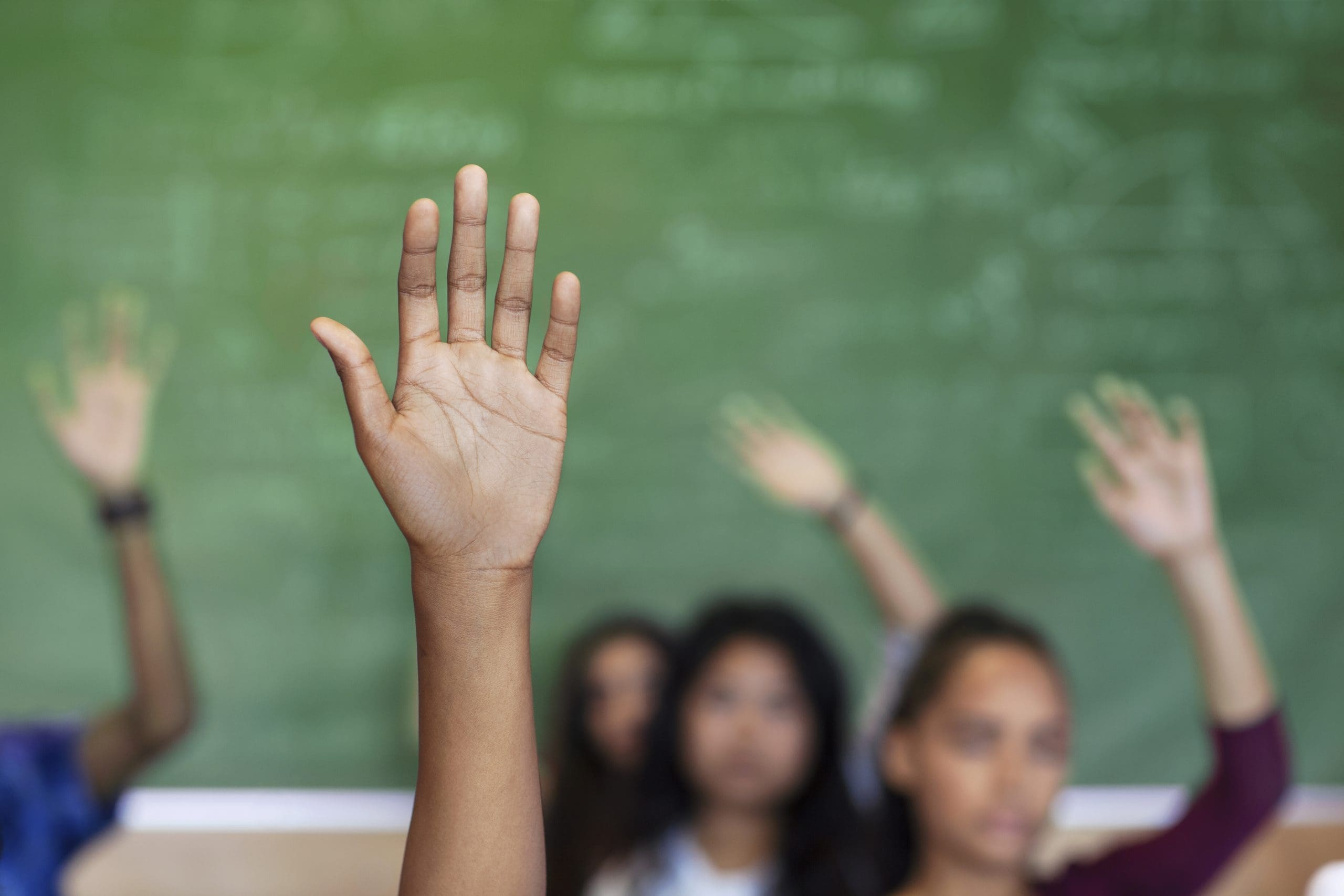 Curious children asking questions in class